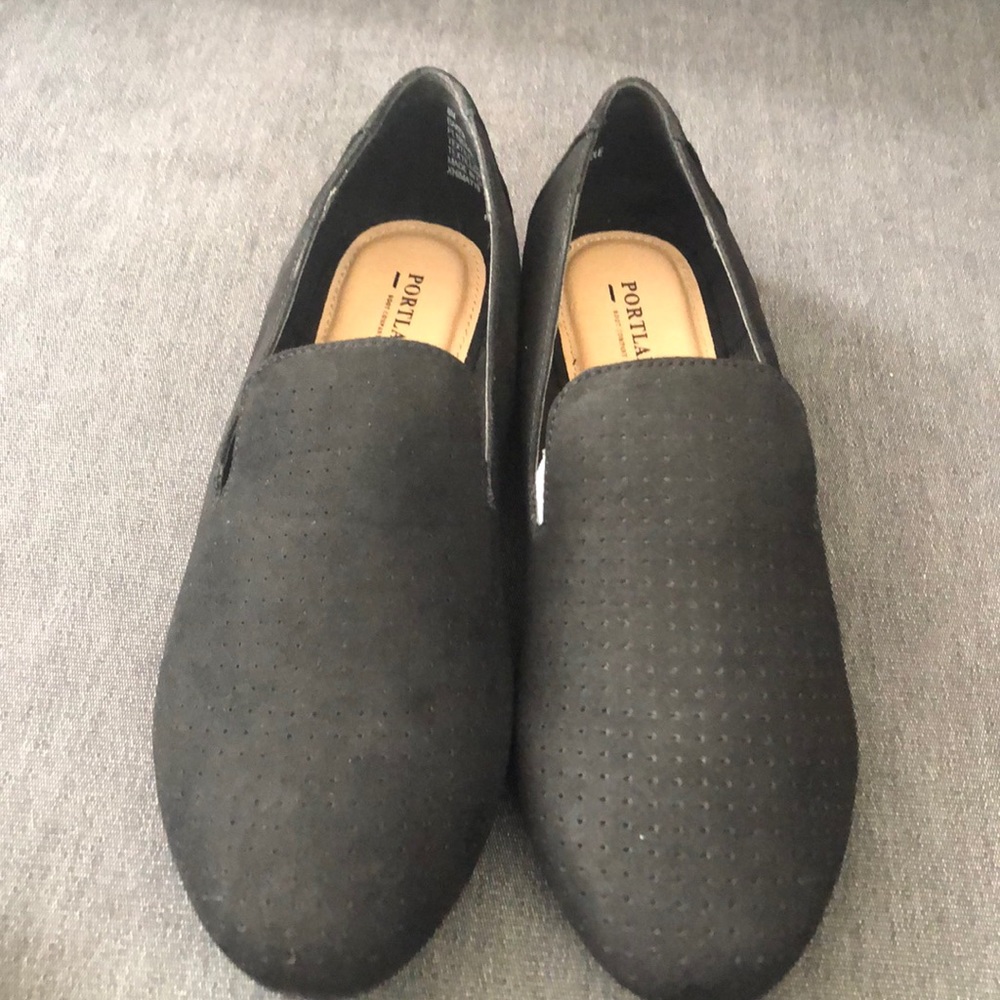 Black loafers with perforated detail
